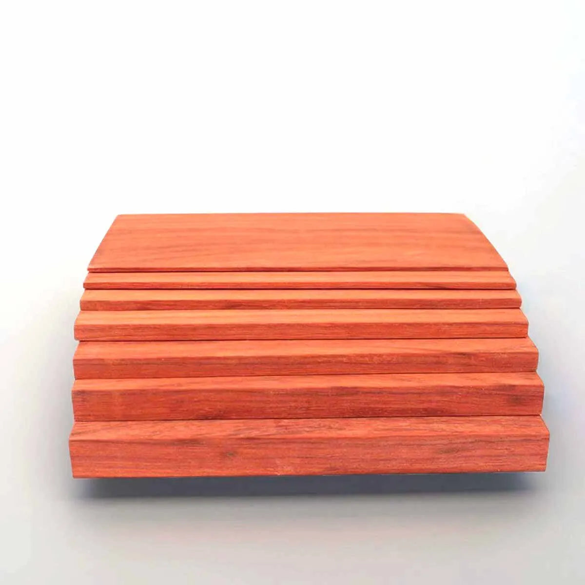 A stack of natural African red rosewood boards for DIY crafts, showing the wood grain and color.