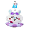 A white plush keychain charm of a cat wearing purple sunglasses and sitting on a purple swimming ring with a pool party tag.