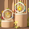 A set of baby musical instruments including a hand drum and shake rattle featuring cute animal designs.
