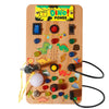 A wooden Montessori busy board featuring various colorful buttons, switches, and dinosaur figures for interactive play.
