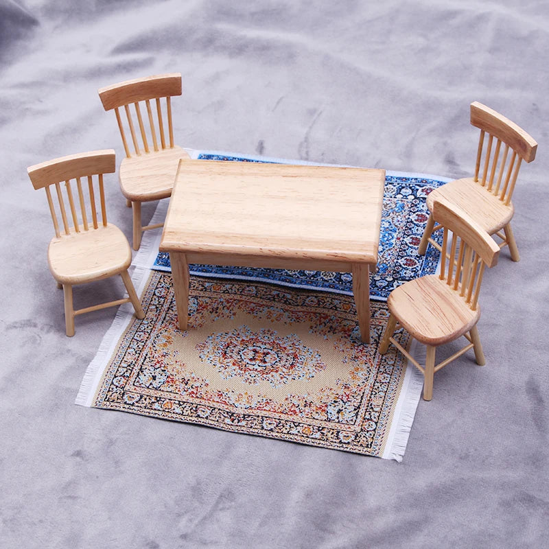 A set of four light wood chairs and a rectangular wooden table placed on a miniature Turkish style carpet mat for dollhouse d