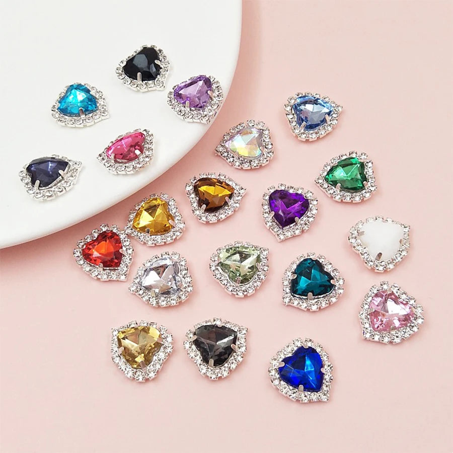 A collection of heart-shaped flatback sew-on rhinestones in various colors and clear settings.