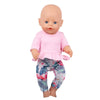 A baby doll wearing a pink shirt and floral print pants.