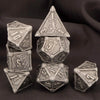 A set of seven premium metal polyhedral dice, including a d10 and d6, displayed on a dark background.