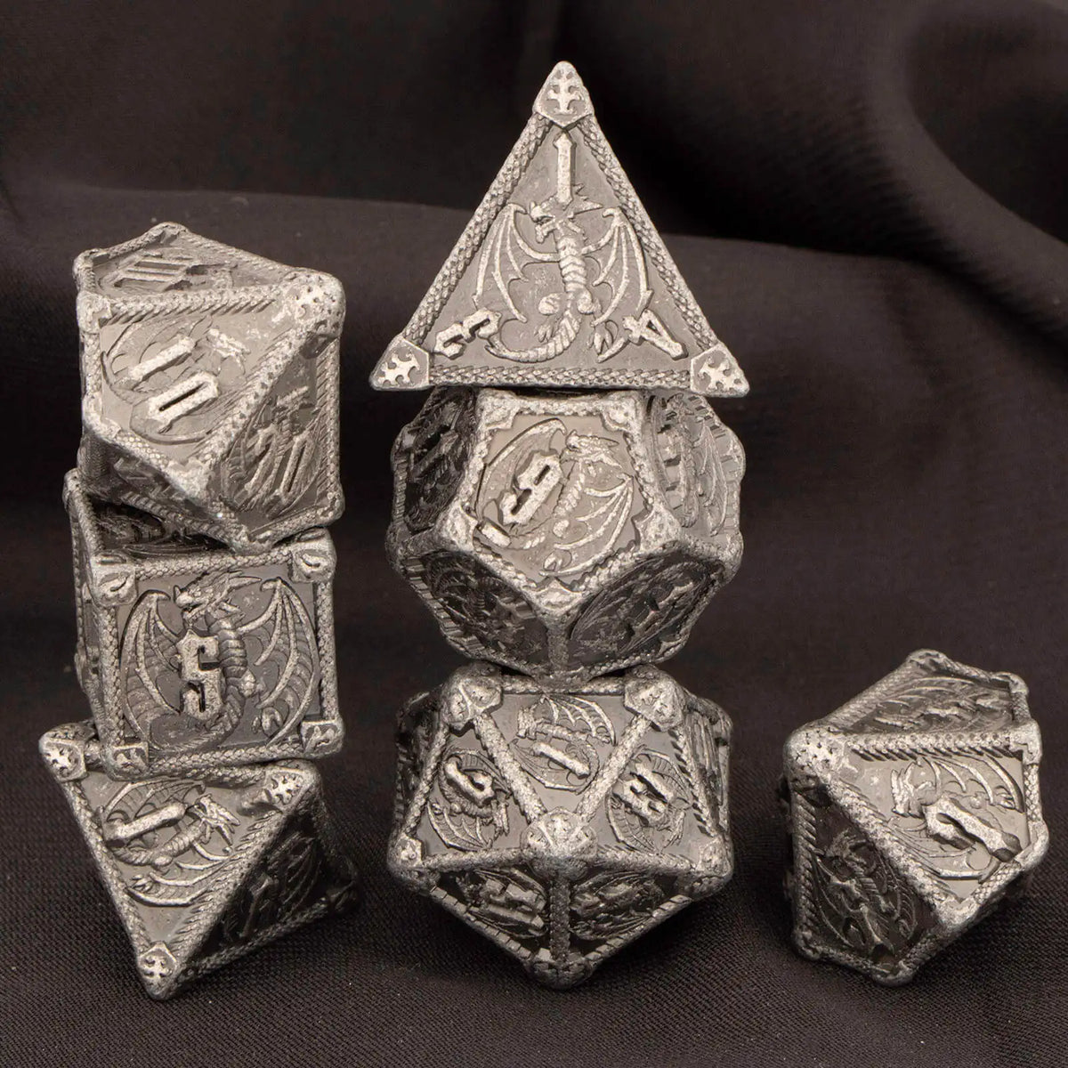 A set of seven premium metal polyhedral dice, including a d10 and d6, displayed on a dark background.