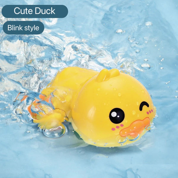 A yellow cute duck toy with blinking eyes is shown submerged in clear water.