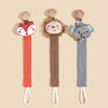 Three elephant pacifier holders in wood and fabric textures displayed against a light background.