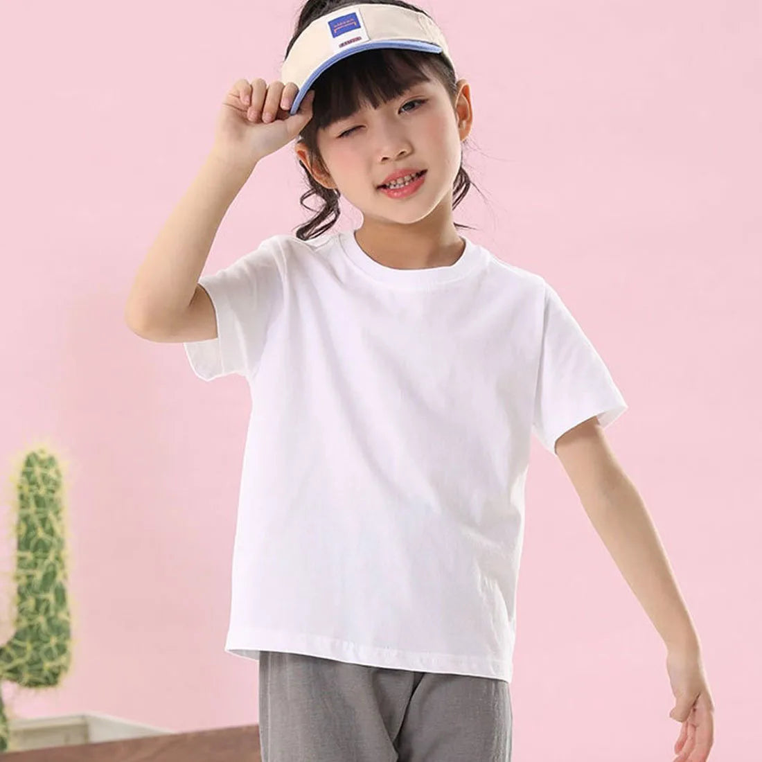 A young girl wearing a white classic cotton crew neck t-shirt and a light-colored headband.