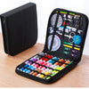 A black complete sewing kit with various tools and threads is displayed inside an open travel storage box.