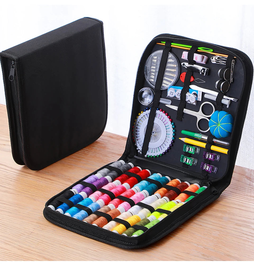 A black complete sewing kit with various tools and threads is displayed inside an open travel storage box.