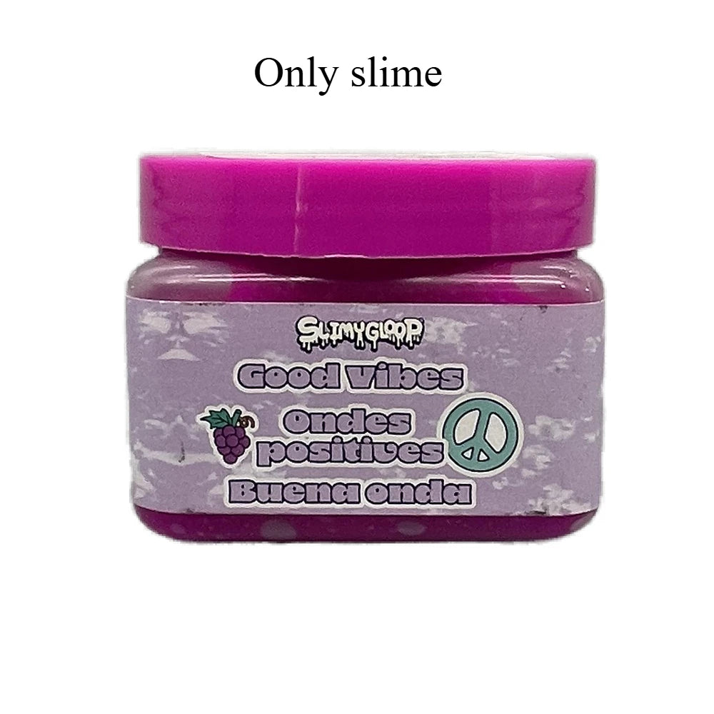 A purple jar of slime labeled Good Vibes Ondes positives Buena onda with a peace sign symbol.