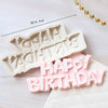 A set of white silicone cake molds shaped like 'HAPPY BIRTHDAY' and other baby-themed items.