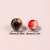 Two gradient crystal glass beads, one black with gold crackle and one red, shown against a light background.