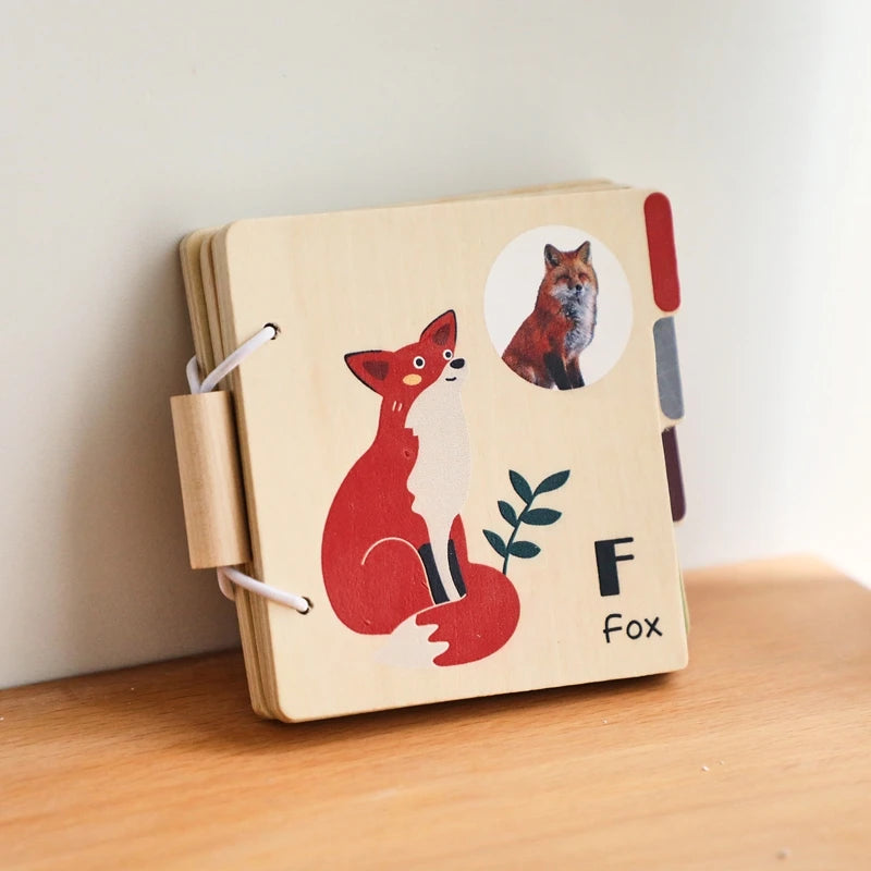 A wooden flap book featuring a red fox illustration, designed as an interactive learning toy for toddlers.