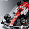 A red and white formula racing car model with visible steering components and linkages.