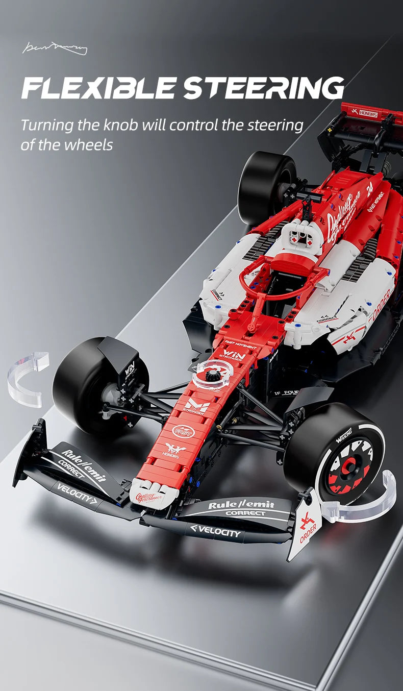 A red and white formula racing car model with visible steering components and linkages.