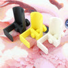 Three adjustable diamond painting canvas stands in black, yellow, and white are displayed on a pink patterned surface.