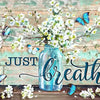 A watercolor painting featuring white blossoms and blue butterflies on a wooden background.