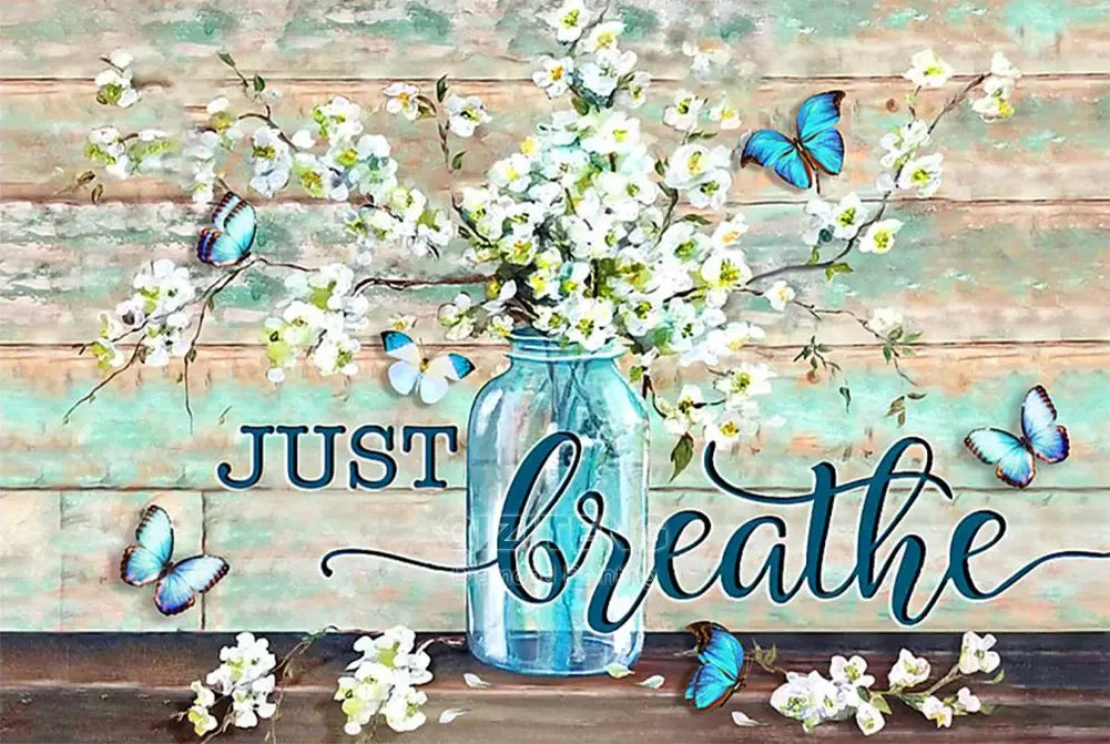 A watercolor painting featuring white blossoms and blue butterflies on a wooden background.