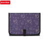 Purple fabric diaper changing pad featuring a pattern of white swans and small stars.