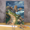 A painting by numbers kit featuring a seascape landscape with rocky cliffs and waves.