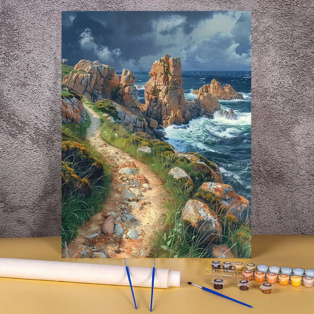 A painting by numbers kit featuring a seascape landscape with rocky cliffs and waves.