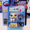 A set of three small animal figures, including a white cat, a purple dog, and a light blue creature, packaged in clear plasti