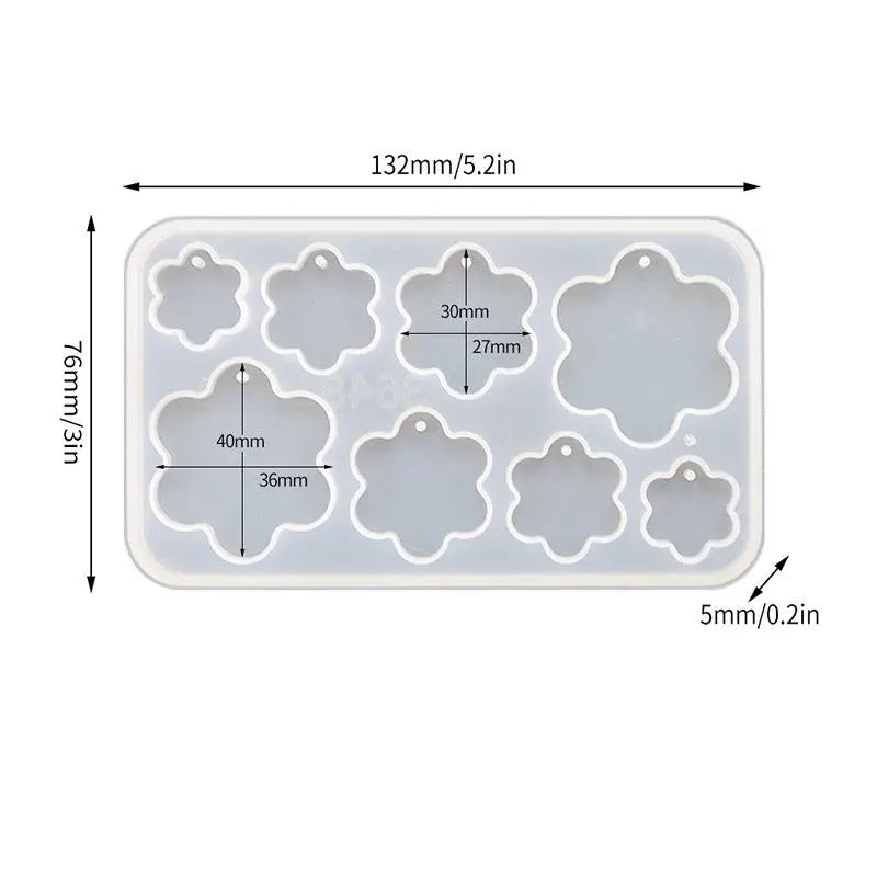 A white silicone mold set with various geometric shapes for making epoxy resin earrings and pendants.
