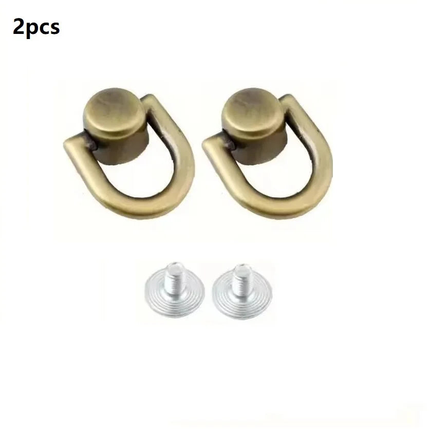 Two brass D-shaped metal bag handles with screws for DIY purse straps and craft hardware