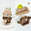 A knitted doll sweater outfit set featuring a brown and green textured knit with a smiling face detail.