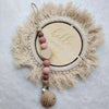 A personalized wooden baby pacifier clip featuring silicone beads and a natural fiber wreath.