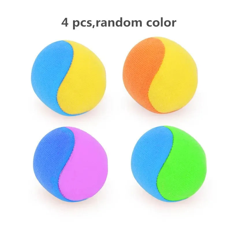 Four fuzzy dodgeball-like balls in random colors including blue, yellow, orange, and purple.