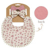 A pink floral fabric bib with a scalloped edge and a matching pink bow headband shown from the back.