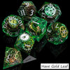 A collection of green resin dice showing various numbers and symbols, including a die labeled Have Gold Leaf.
