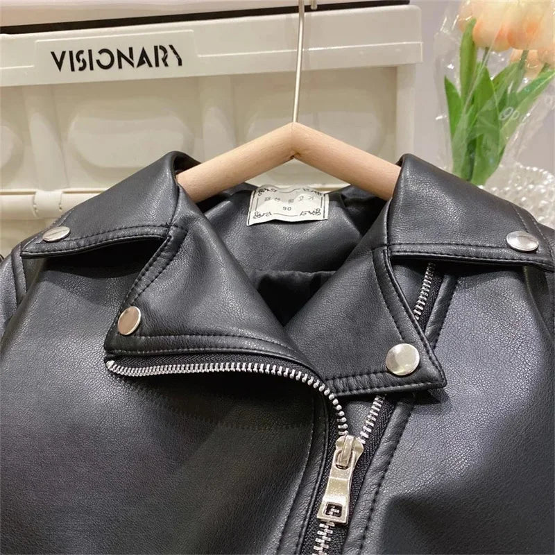 A black faux leather zip-up jacket displayed on a hanger against a white background.