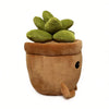 A plush toy shaped like an elephant pot with green succulent plants growing out of the top.