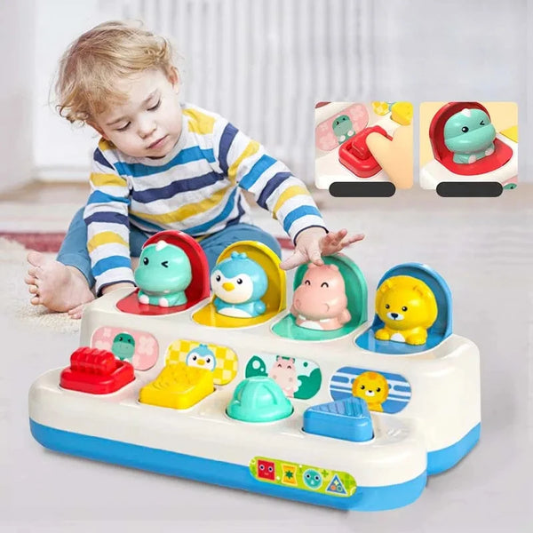 A baby is interacting with an interactive pop-up sensory toy featuring various colorful, soft-looking animal figures.