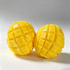 A bright yellow mango-shaped squishy stress relief ball with a textured surface is shown on a white background.
