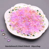 A plate filled with pink and purple water drop glass beads for jewelry making