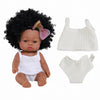 A doll with curly black hair wearing a white lace outfit and matching diaper cover.