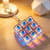 A clear, light-up fidget keychain featuring a grid of blue and purple LED lights.