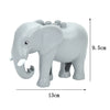 A gray elephant building block with a trunk and large ears, shown from the side.
