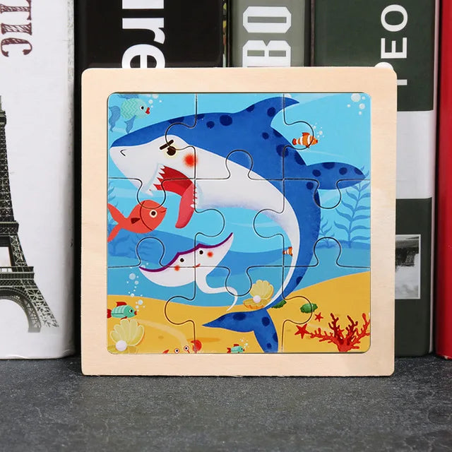 A wooden jigsaw puzzle featuring blue and white fish and colorful sea life designs on a light wood background.