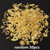 A pile of random gold metal charms and findings for DIY jewelry making