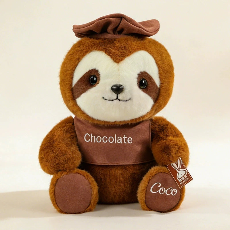 A brown sloth plush toy with a brown hat and a chocolate-colored chest, sitting on a white background.