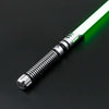 A premium metal lightsaber with an illuminated green blade and metallic hilt is shown against a dark background.