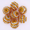 A cluster of ten mixed two-tone striped resin beads in a golden yellow color, used for jewelry making.