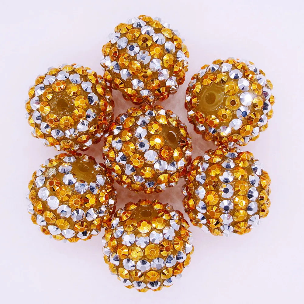 A cluster of ten mixed two-tone striped resin beads in a golden yellow color, used for jewelry making.