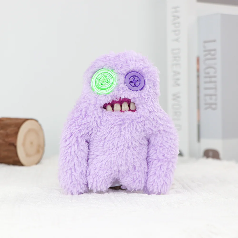 A purple, fuzzy monster plush toy with glowing green and purple eyes sits on a white surface.