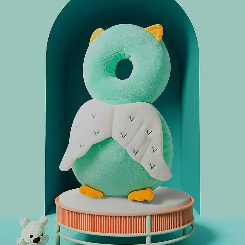 A soft teal security pillow backpack for newborns is displayed against a mint green arched background.